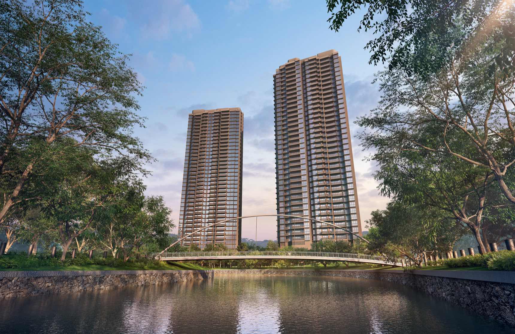 Developer render of the two River Modern towers at dusk, seen across the river with the arched footbridge in front
