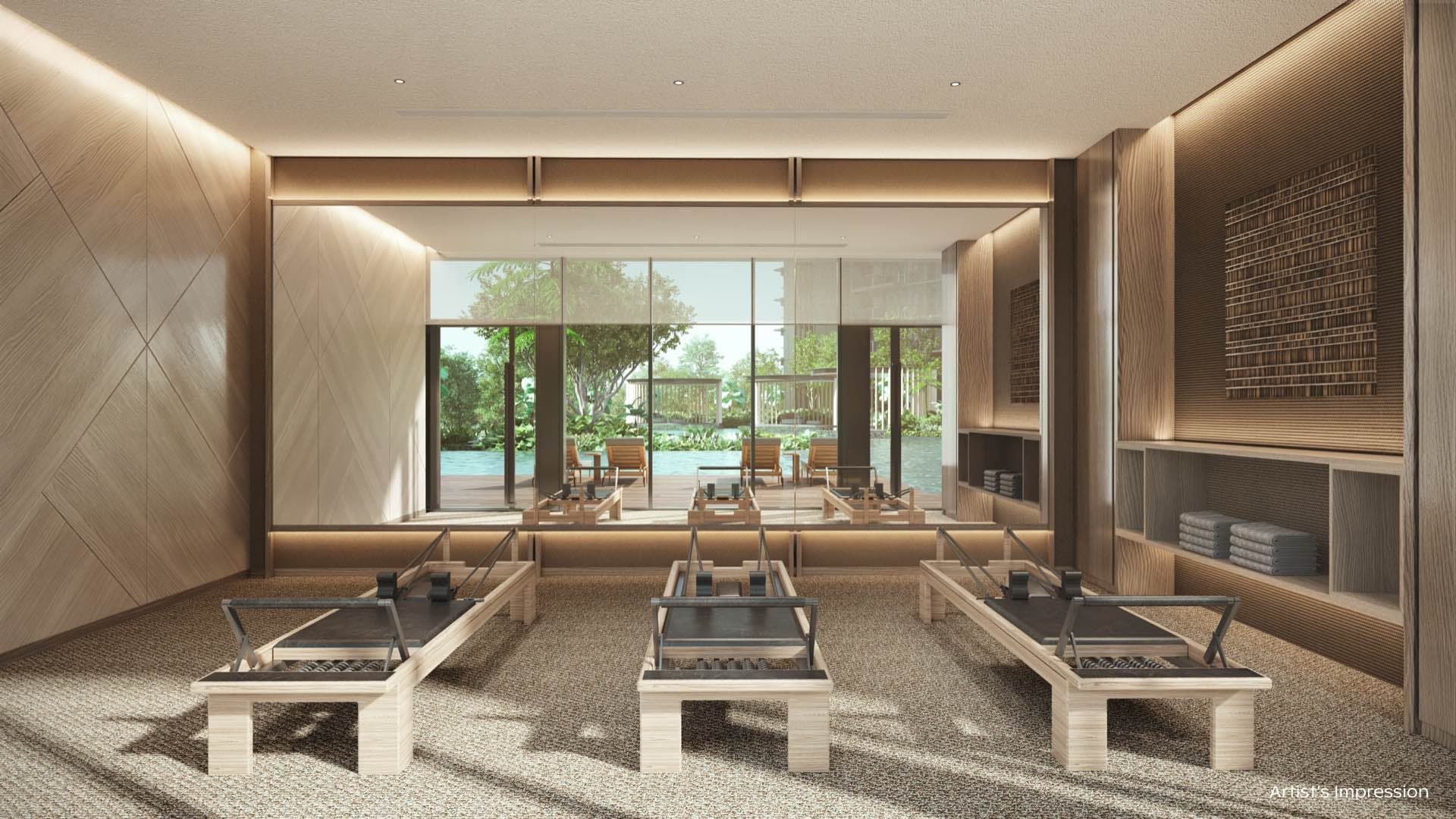 Developer render of the Pilates studio, reformer machines facing a mirrored wall and windows onto the pool
